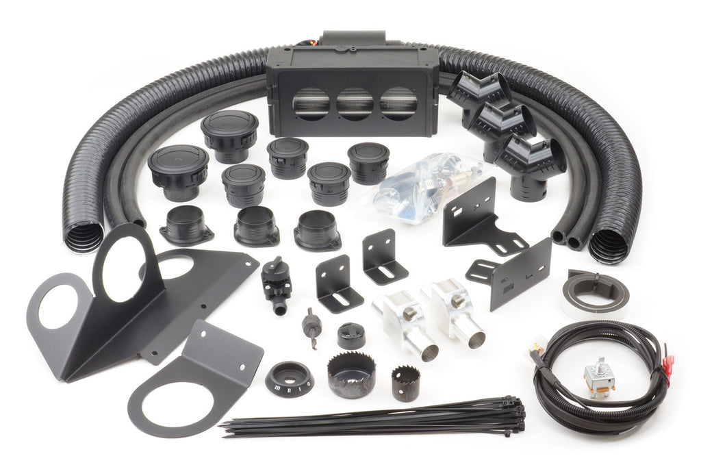 The Polaris RZR 1000 (2014-2018) & RZR 1000S (2019-2021) Ice Crusher Cab Heater kit includes black hoses, air vents, brackets, connectors, plastic ties, metal fittings, screws, and wires arranged on a white background.