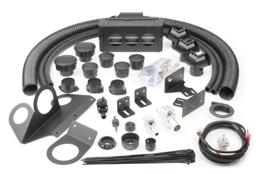 A Polaris RZR 900/900-4 (2015-2020) Ice Crusher Cab Heater kit is displayed on a white surface, featuring black hardware like hoses, vent covers, brackets, connectors, wiring, zip ties, screws, and fittings for easy installation.