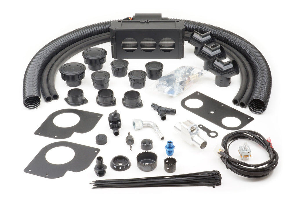 The Kawasaki Mule 4000/4010 and Trans (2009-2021) Ice Crusher Cab Heater kit is displayed on a white surface, showing black hoses, round vents, fittings, mounting plates, wiring, zip ties, screws, connectors, and an air distribution box.