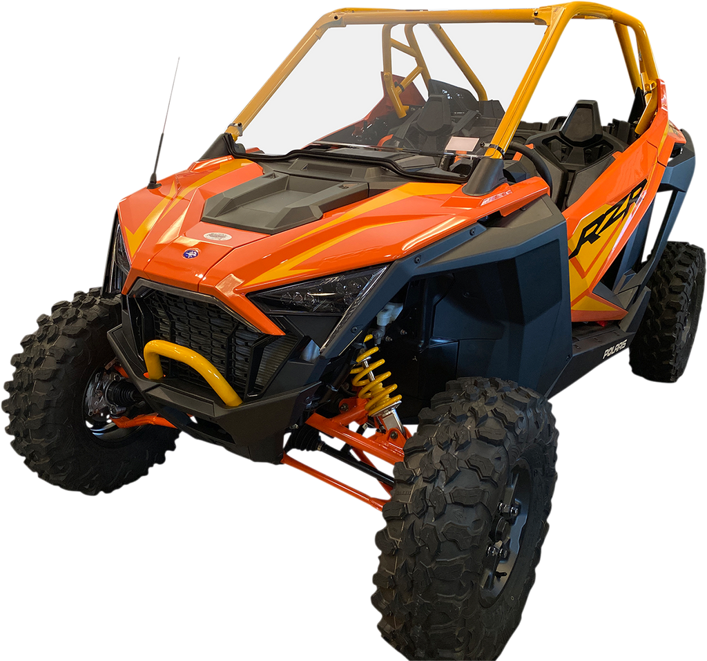 A bright orange and yellow off-road utility vehicle with large rugged tires, angular headlights, open cabin, protective roll cage, and bold RZR branding on the side, designed for all-terrain driving and adventure.