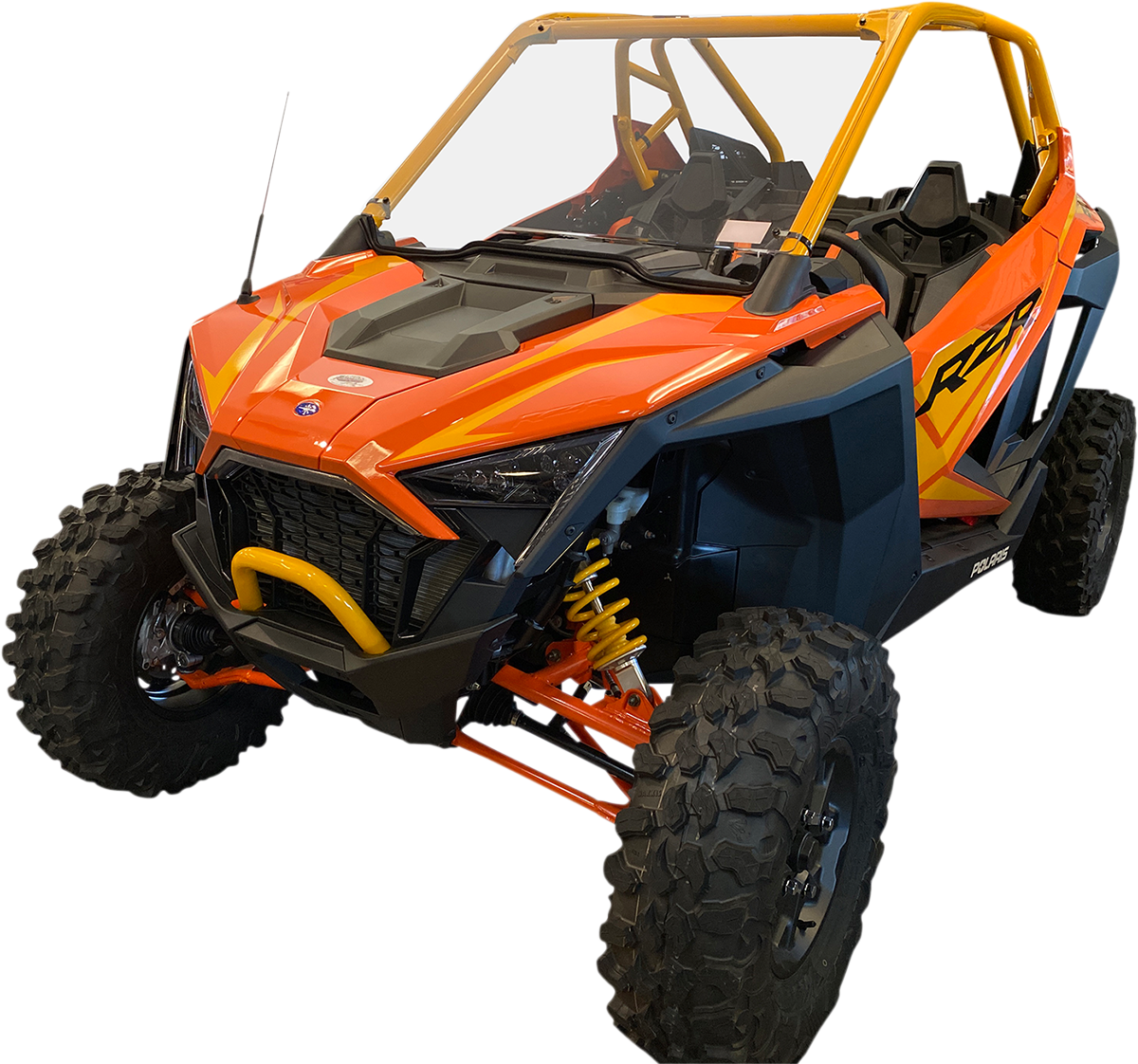 A bright orange and yellow off-road utility vehicle with large rugged tires, angular headlights, open cabin, protective roll cage, and bold RZR branding on the side, designed for all-terrain driving and adventure.