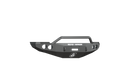 A 2010-2018 Ram 2500 Stealth Front Winch Bumper Pre-Runner Guard in texture black, featuring angular edges, round fog light cutouts, central grill guard bar, white “ROAD ARMOR” text, shield logo under the winch mount—shown on white background.