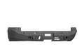 The 2010-2018 Ram 2500 Stealth Rear Winch Bumper (Texture Black, fits Warn M8000) features angular edges, sensor holes, accessory cutouts, and the ROAD ARMOR logo in white on the right. The heavy-duty bumper is shown on a plain white background.