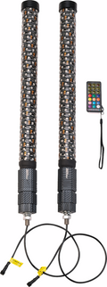 Two black cylindrical LED whip lights with patterned coverings are shown side by side. Each has a cord attached at the bottom. Next to them is a small rectangular remote control with colorful buttons and a black strap.