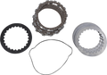 A set of motorcycle clutch plates and related components, including a stack of friction plates (top), a stack of steel plates (right), a round black gasket (left), and an irregularly shaped gasket (bottom), all arranged on a white background.