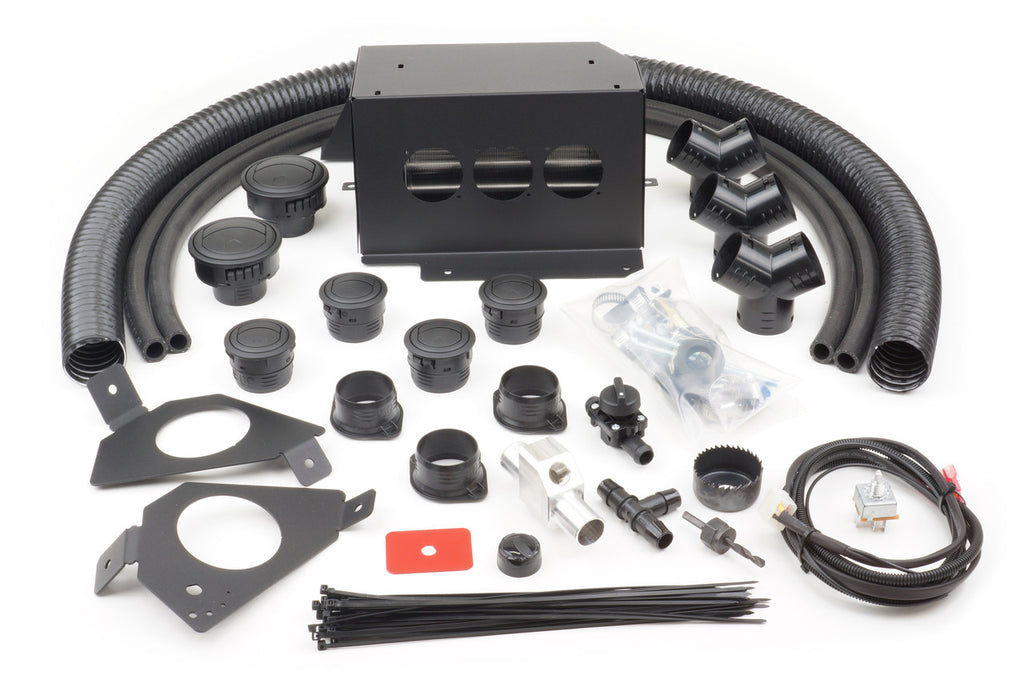 The Kawasaki Teryx 4/800 (2016-2021) Ice Crusher Cab Heater kit includes black plastic and metal HVAC parts—hoses, adapters, connectors, vents, wiring harness, fasteners, cable ties, and a rectangular metal enclosure—displayed on white.