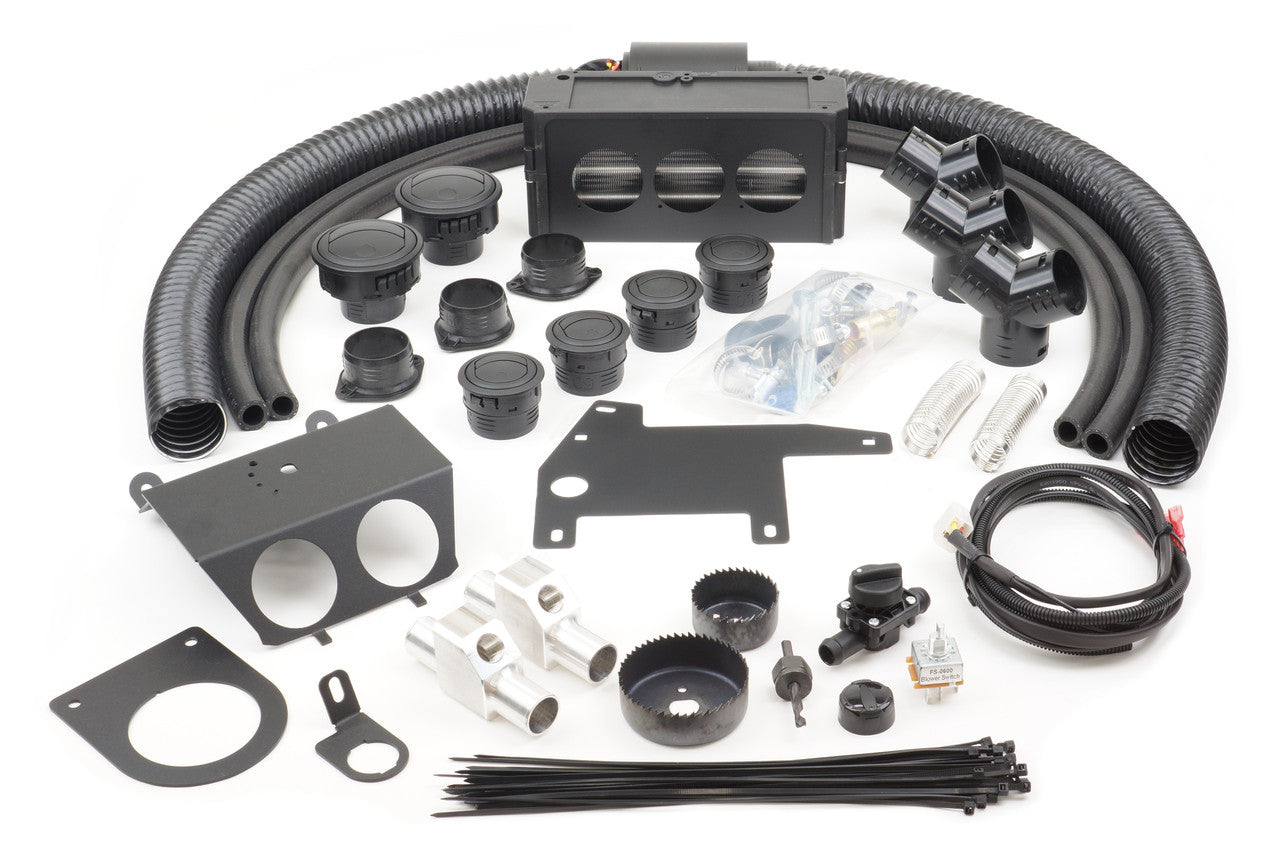 The Can-Am Maverick X3 (2017) - Ice Crusher Cab Heater kit is displayed, featuring flexible hoses, vent covers, brackets, saw bits, cables, connectors, switches, zip ties, and various hardware pieces on a white background.