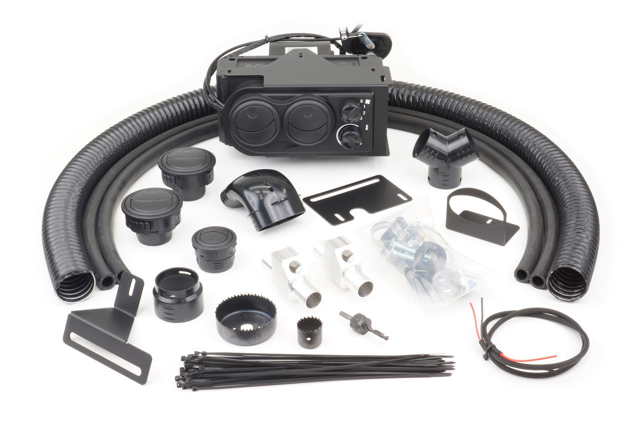 The Polaris RZR 900 (2011-2014) Ice Crusher Cab Heater kit for models with electric power steering is shown neatly laid out, featuring black hoses, vents, connectors, brackets, zip ties, a switch, wiring, hardware, and the central heater unit.