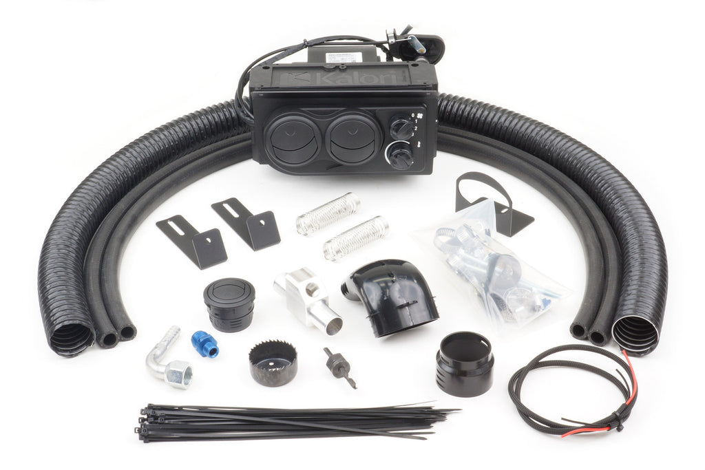 The John Deere Gator 625i Under Dash (2011-2018) Ice Crusher Cab Heater kit includes a black heater unit, hoses, brackets, fittings, clamps, zip ties, wiring, a bag of small parts, and installation accessories arranged on a white background.