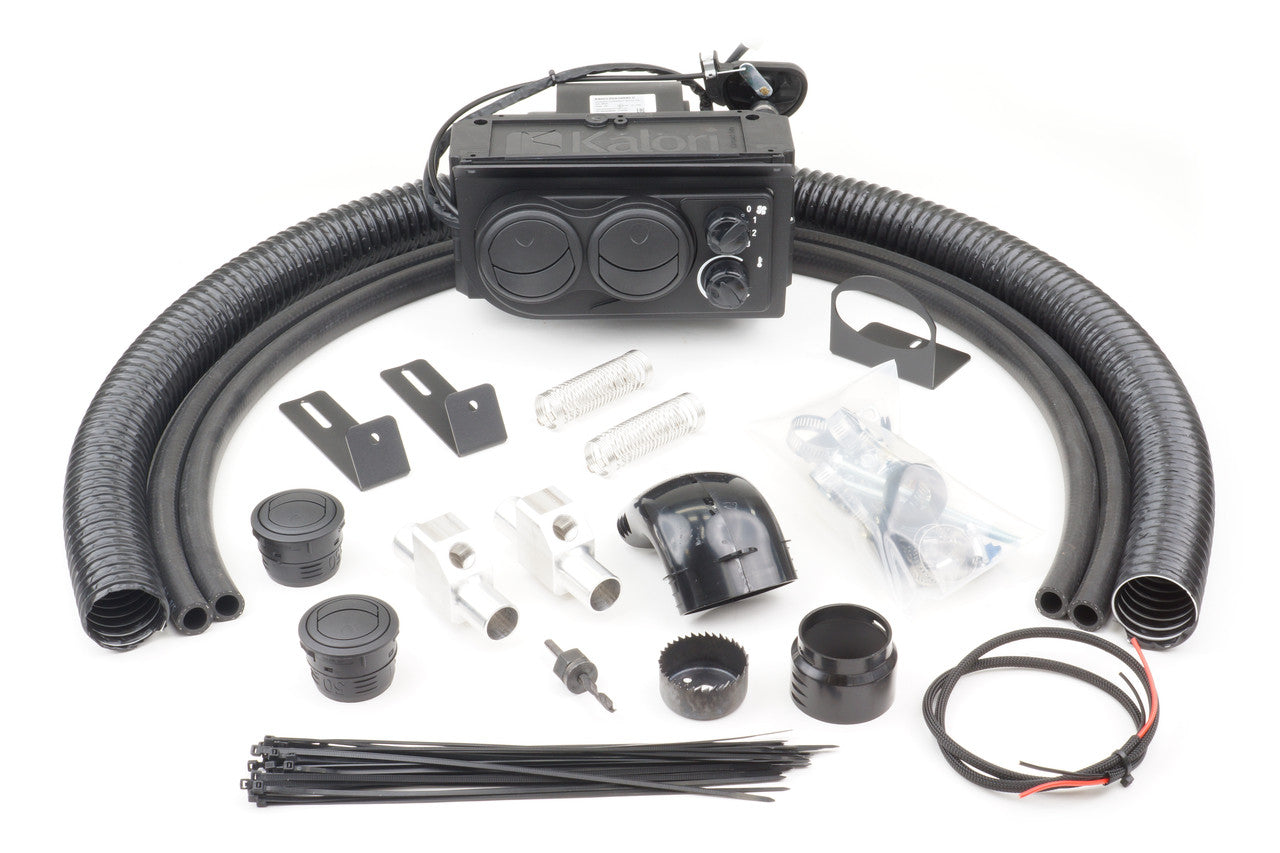 The John Deere 620 (2007-2011) - Ice Crusher Cab Heater kit is shown with a black heater unit, flexible hoses, mounting brackets, vents, connectors, wiring, zip ties, and hardware arranged neatly on a white background.