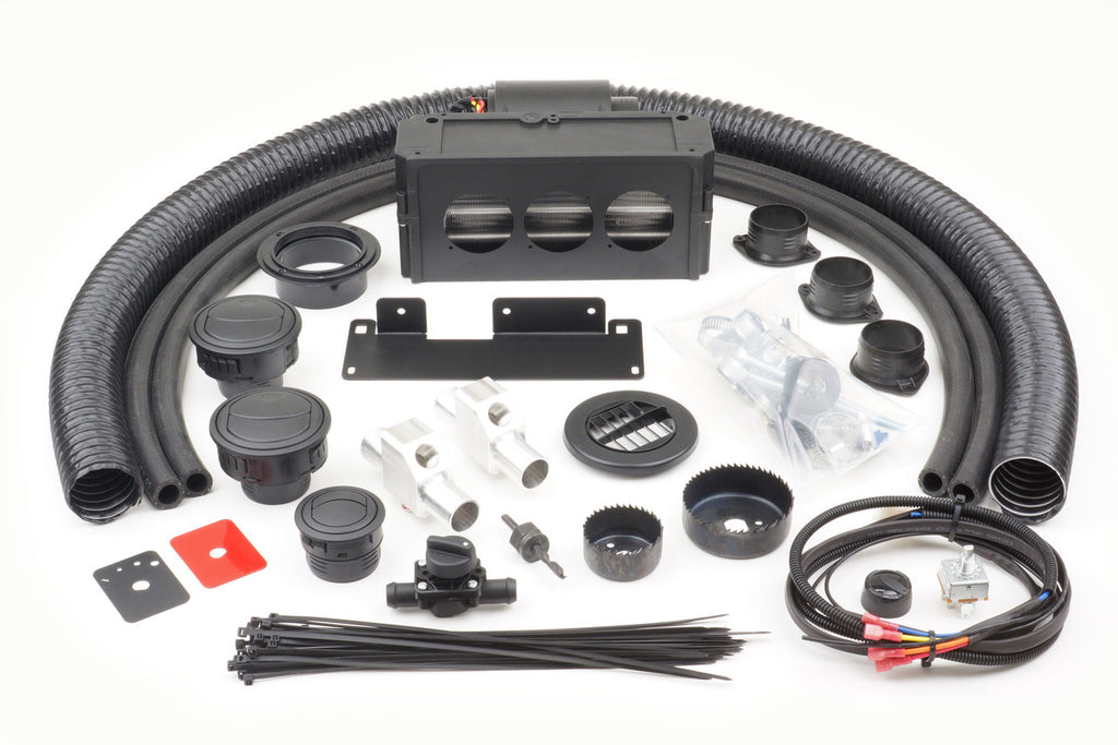 The Honda Pioneer 500/520 (2015-2022) Ice Crusher Cab Heater kit includes black flexible ducts, vents and connectors, metal brackets, a rectangular housing unit, zip ties, wiring harness, cable connectors, mounts, and small hardware components.