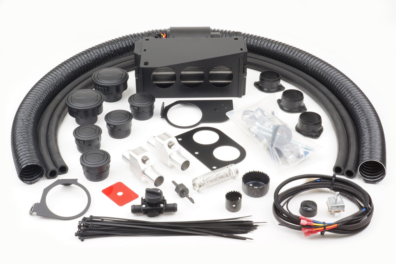 The Arctic Cat Wildcat Trail (2012-2019) Ice Crusher Cab Heater kit includes flexible black hoses, a rectangular vent unit, round ducts, black plastic fittings, hose clamps, zip ties, wiring, brackets, and small metal hardware arranged on a white backgrou