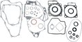 A collection of various engine gaskets arranged on a white background, including large and small gasket shapes with multiple cutouts and holes, circular seals, and irregular outlines, all of which are made from thin metal or composite materials.