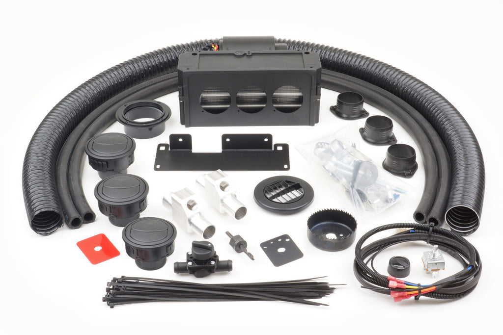 A Honda Pioneer 500 (2015-2016) - Ice Crusher Cab Heater kit shown on a white surface, with black flexible hoses, plastic vents, control knobs, cables with connectors, mounting brackets, metallic connectors, zip ties, and hardware neatly arranged.