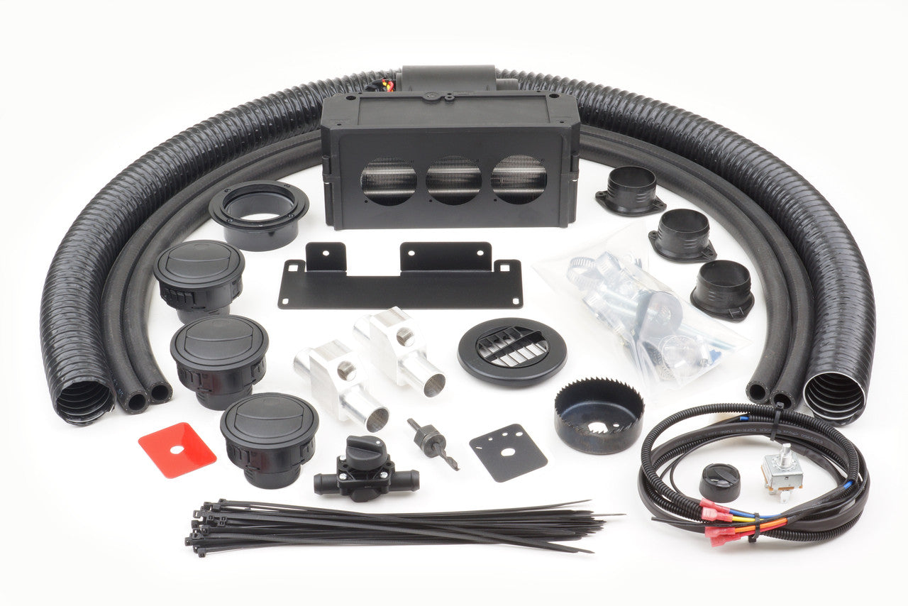 A Honda Pioneer 500 (2015-2016) - Ice Crusher Cab Heater kit shown on a white surface, with black flexible hoses, plastic vents, control knobs, cables with connectors, mounting brackets, metallic connectors, zip ties, and hardware neatly arranged.