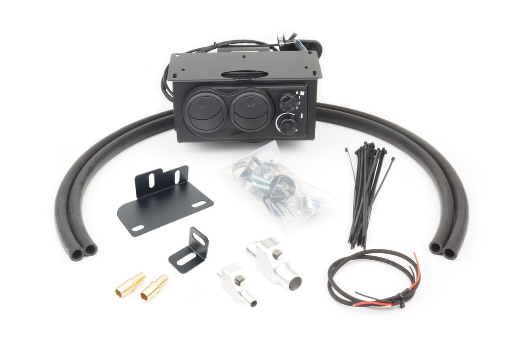 The Kubota RTV500 (2008-2019) Ice Crusher Cab Heater kit includes a black control unit, two large black hoses, zip ties, mounting brackets, brass fittings, metal clamps, screws, and a black-and-red wire arranged on a white background.