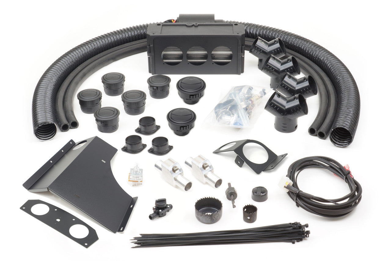 The Can-Am Maverick 1000 (2013-2018) Ice Crusher Cab Heater kit is displayed on a white background, with air ducts, vent covers, wiring, brackets, adapters, screws, zip ties, and mounting hardware neatly arranged for clarity.