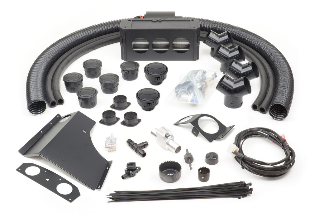 The Can-Am Maverick 800 (All Model Years) Ice Crusher Cab Heater installation kit is displayed on a white background, featuring flexible ducts, vents, connectors, brackets, wiring harness, zip ties, screws, relays, and various fittings.
