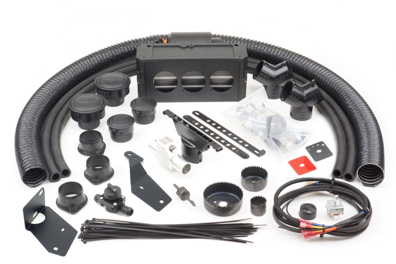 Ice Crusher Cab Heater components for Kubota RTV-X900 (2013-2021)—including hoses, connectors, brackets, cable ties, wiring, screws, a control box, and hole saws—are neatly arranged on a white surface.