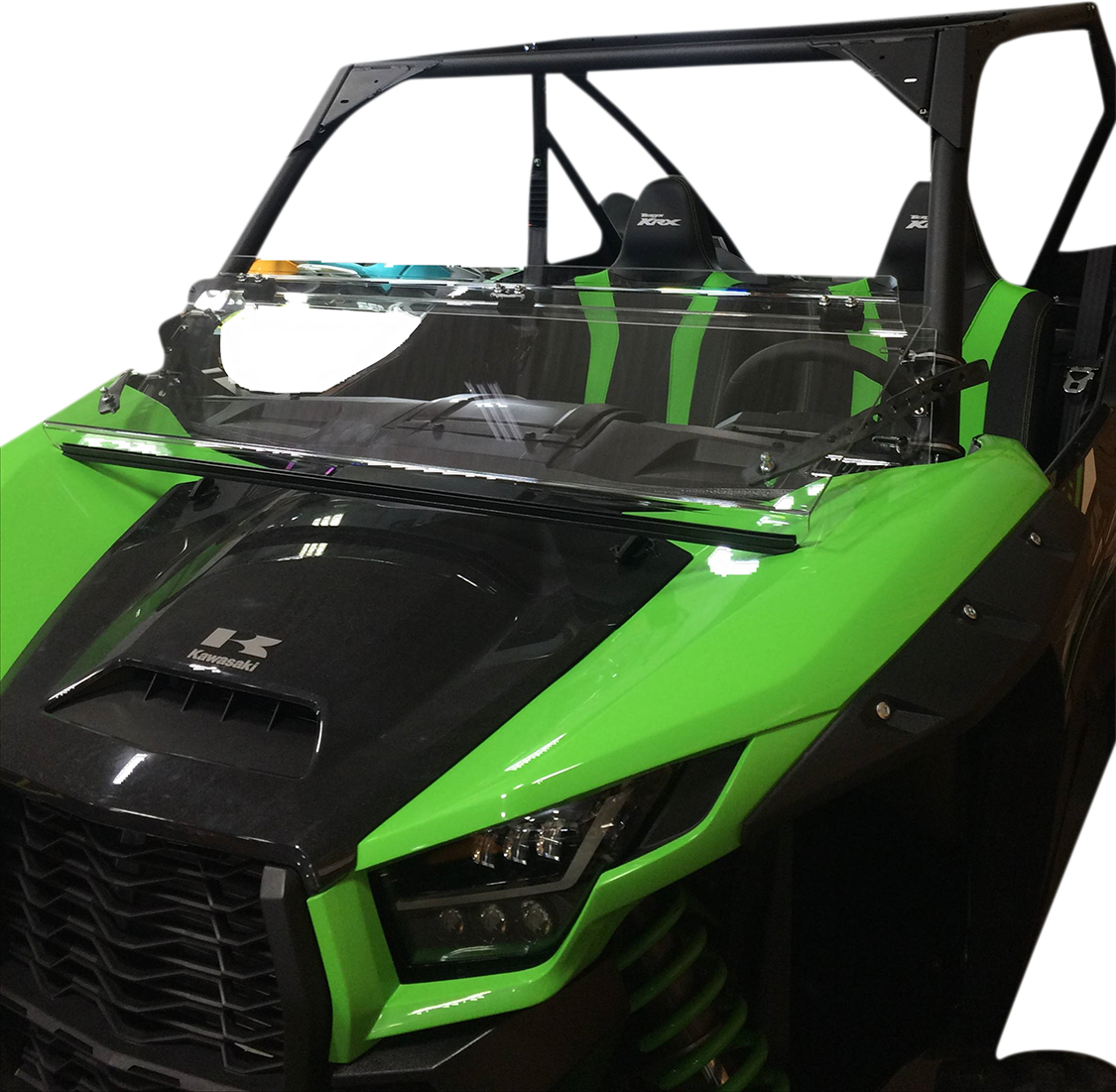 A green and black off-road utility vehicle with a partial windshield, open top, and two seats. The front features angular headlights, a black grille, and visible suspension springs beneath the hood. The background is white.