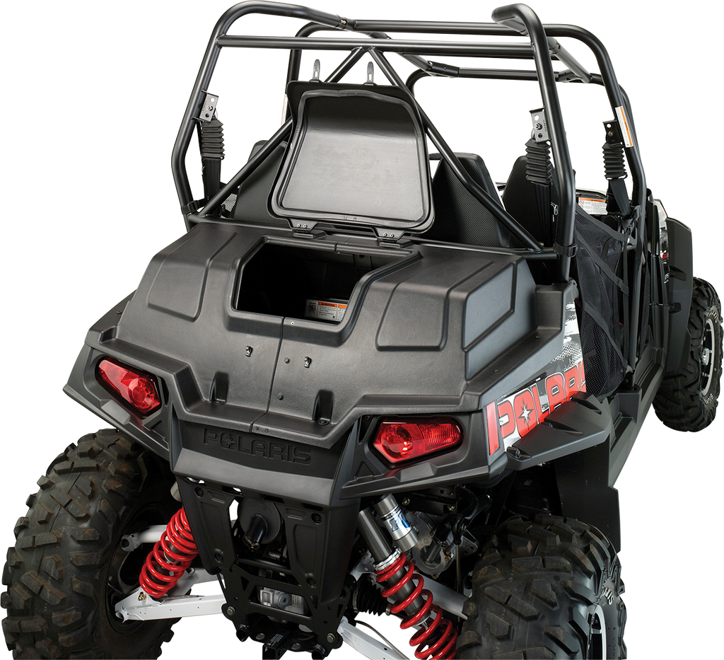 Rear view of a black off-road Polaris vehicle with red suspension springs, rugged tires, a roll cage, and open cargo space. The Polaris logo is visible, and red taillights are illuminated. The setting is a plain, light background.