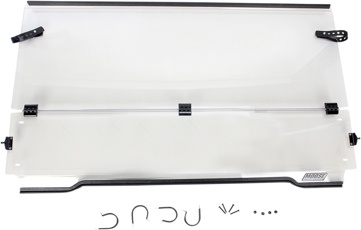 A clear, rectangular windshield with black mounting brackets and hardware attached. The bottom edge features a black border and a Moose logo. Below the windshield, several small, black mounting parts and fasteners are arranged on a white background.