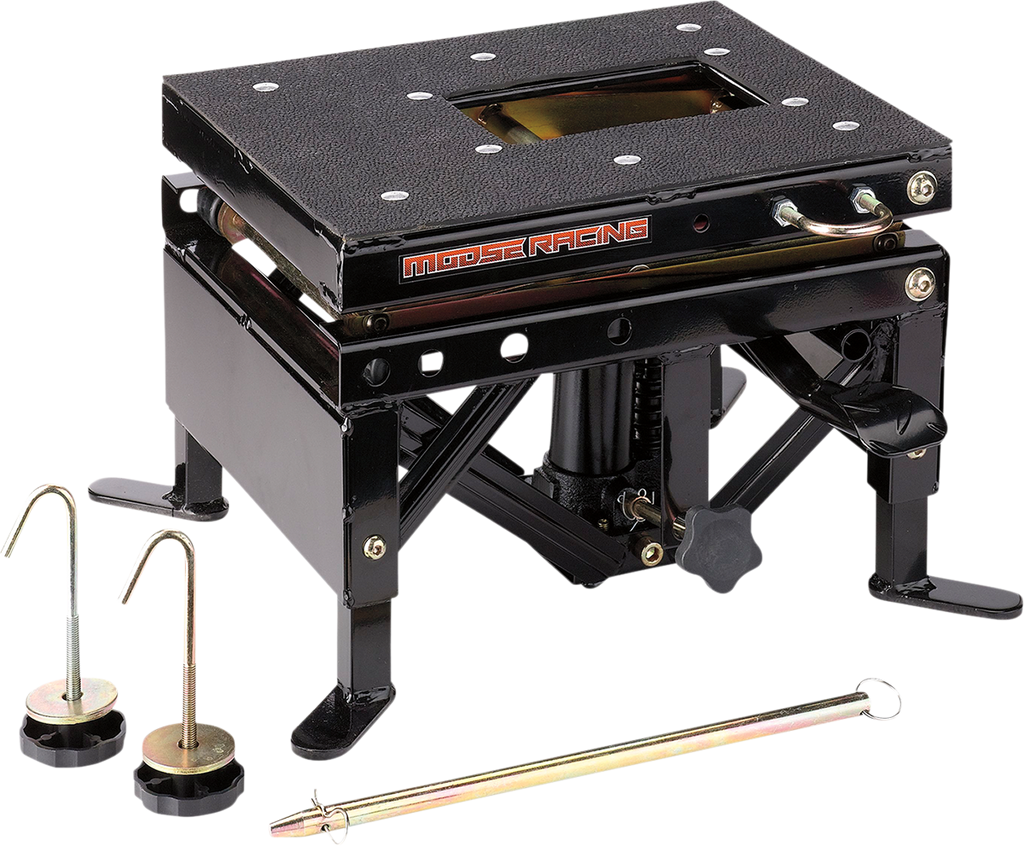 A black metal motorcycle lift table with a textured top, side crank handle, and Moose Racing logo. Two silver and black pins with hooks and a long metal rod are placed in front, all on a white background.