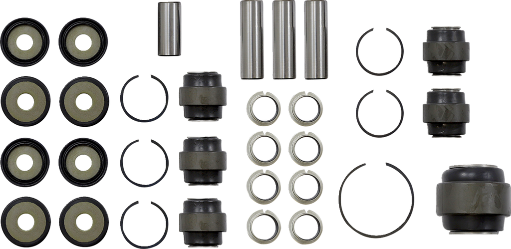 A neatly arranged set of metal and rubber suspension bushings, spacers, rings, and cylindrical pins on a white background, viewed from above. The components are grouped by type in rows and columns, showing all pieces clearly for identification.