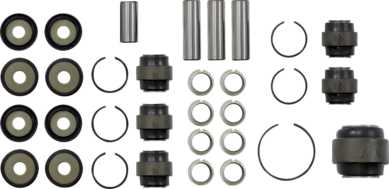 A neatly arranged set of metal and rubber suspension bushings, spacers, rings, and cylindrical pins on a white background, viewed from above. The components are grouped by type in rows and columns, showing all pieces clearly for identification.