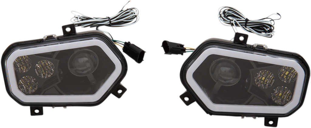 Two black, angular LED car fog lights with clear covers are shown side by side. Each light has three circular LED clusters and a larger single lens inside, with attached wiring and black connectors extending from the top. The lights rest on a white backgr