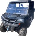 A black CF MOTO utility terrain vehicle (UTV) with large off-road tires, a roof, clear front windshield, and a winch mounted on the front bumper, pictured from the front left angle on a white background.