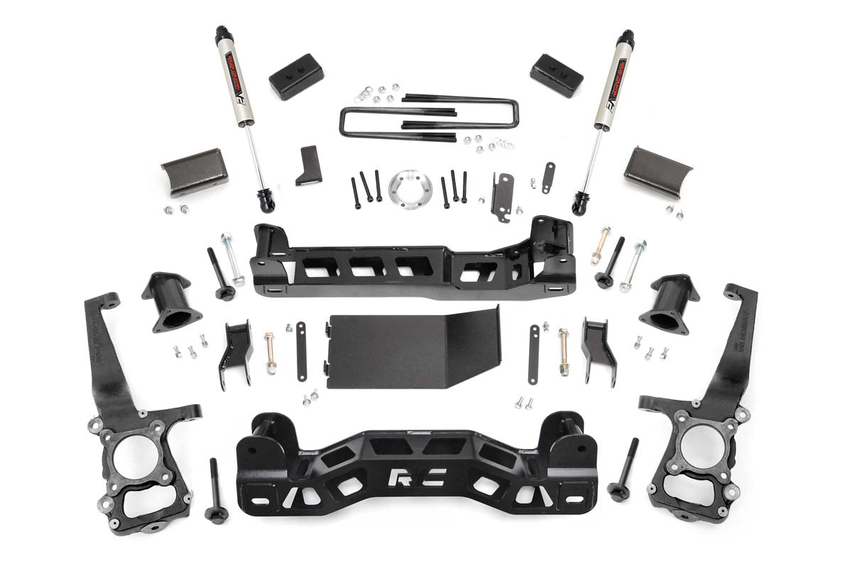 The 4 Inch Lift Kit | V2 for Ford F-150 4WD (2011-2014) includes black steel brackets, crossmembers, knuckles, shock absorbers, bolts, nuts, washers, and spacers neatly separated and displayed on a white background.