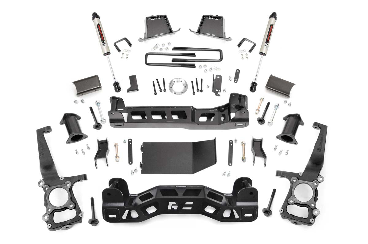 The 6 Inch Lift Kit | V2 for Ford F-150 4WD (2011-2014) is displayed on a white background, featuring black steel brackets, crossmembers, shocks, bolts, spacers, control arms, and mounting hardware arranged symmetrically.