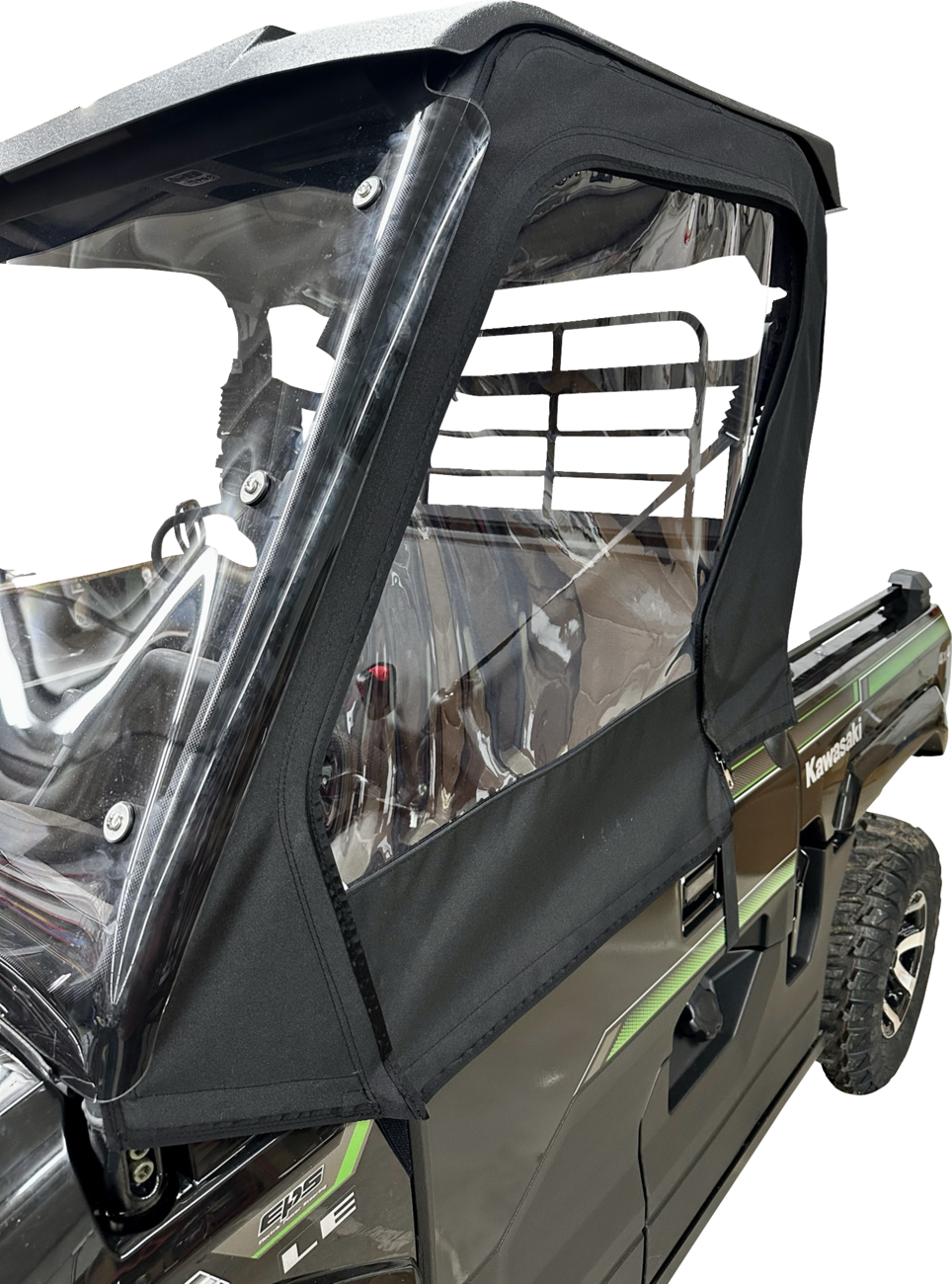 Close-up of a black Kawasaki utility vehicle with a clear plastic and black fabric cab enclosure. The enclosure covers the side window and door area, secured with zippers and fasteners. The rear cargo area and metal rack are visible.