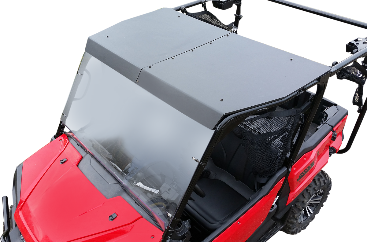 A red utility terrain vehicle (UTV) with a black, solid roof and clear windshield. The seats and steering wheel are visible inside. The image is taken from above, showing the vehicles front and side, with visible roll cage and tire.