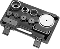A black plastic tool case containing various circular metal discs and rings of different sizes, arranged neatly in molded slots, with two latches in front and a molded handle in the center. The pieces appear to be part of an automotive or mechanical tool 