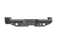 The 2017+ Ford F-250 Vaquero Rear Non-Winch Bumper features a textured black finish, angular design, mounting holes and cutouts, a central mounting plate, and an etched logo on the right side. The background is transparent.