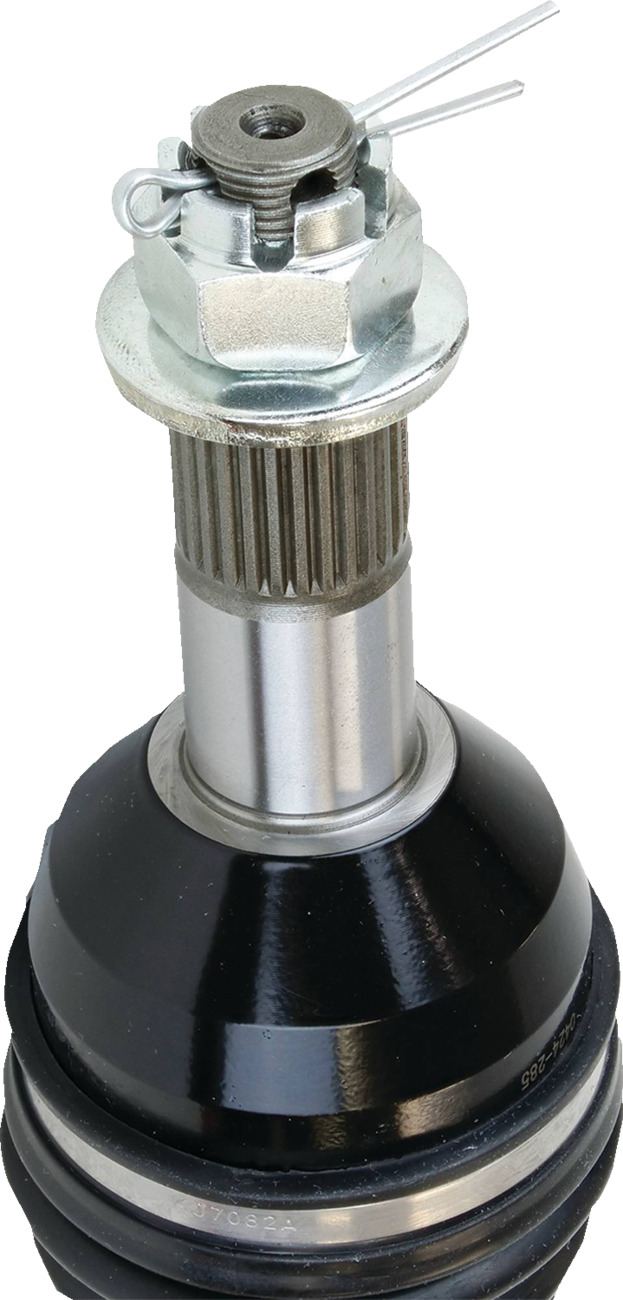 Close-up of a CV (constant velocity) joint, showing a shiny metal splined shaft topped with a castellated nut secured by a cotter pin. The joint has a black protective rubber boot at the base, with visible reflections on its surface. The background is pla