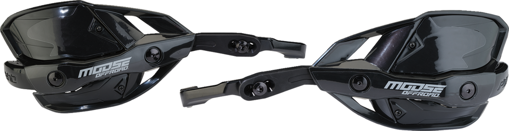 Two black plastic off-road motorcycle handguards with angular designs and Moose Offroad branding in white. The handguards feature adjustment points and mounting hardware, designed to protect hands during riding. Both are shown from different angles on a w