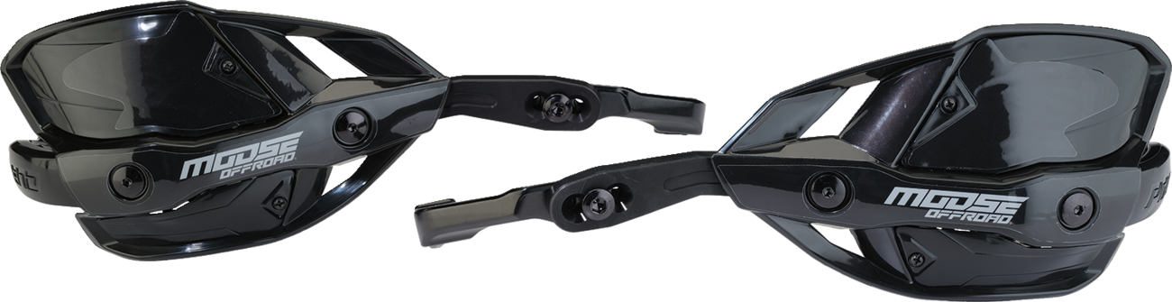 Two black plastic off-road motorcycle handguards with angular designs and Moose Offroad branding in white. The handguards feature adjustment points and mounting hardware, designed to protect hands during riding. Both are shown from different angles on a w