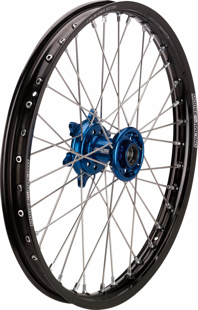 A spoked motorcycle wheel with a black rim, thin silver spokes, a metallic blue hub, and Moose Racing branding on the rim. The wheel is photographed against a white background, showing its detailed construction and components.