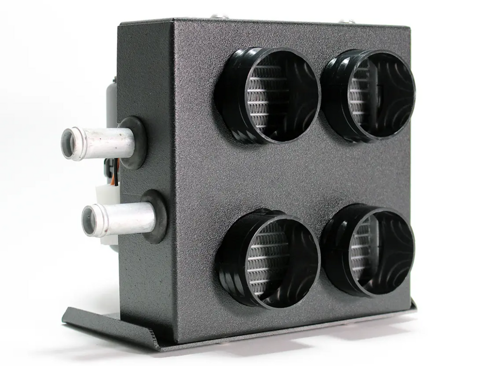 The Inferno Cab Heater Kit With Defrost for 2014-Current Honda Pioneer 700 features a black rectangular metal box with four round front air vents, two silver pipes on the left, grill interiors, and a flat base—ideal as an automotive HVAC component.