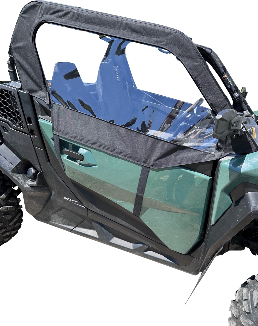 Side view of a green off-road utility vehicle with a black frame door featuring a clear plastic window. The rugged vehicle has large treaded tires, visible seats inside, and is set against a plain white background.