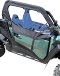 Side view of a green off-road utility vehicle with a black frame door featuring a clear plastic window. The rugged vehicle has large treaded tires, visible seats inside, and is set against a plain white background.
