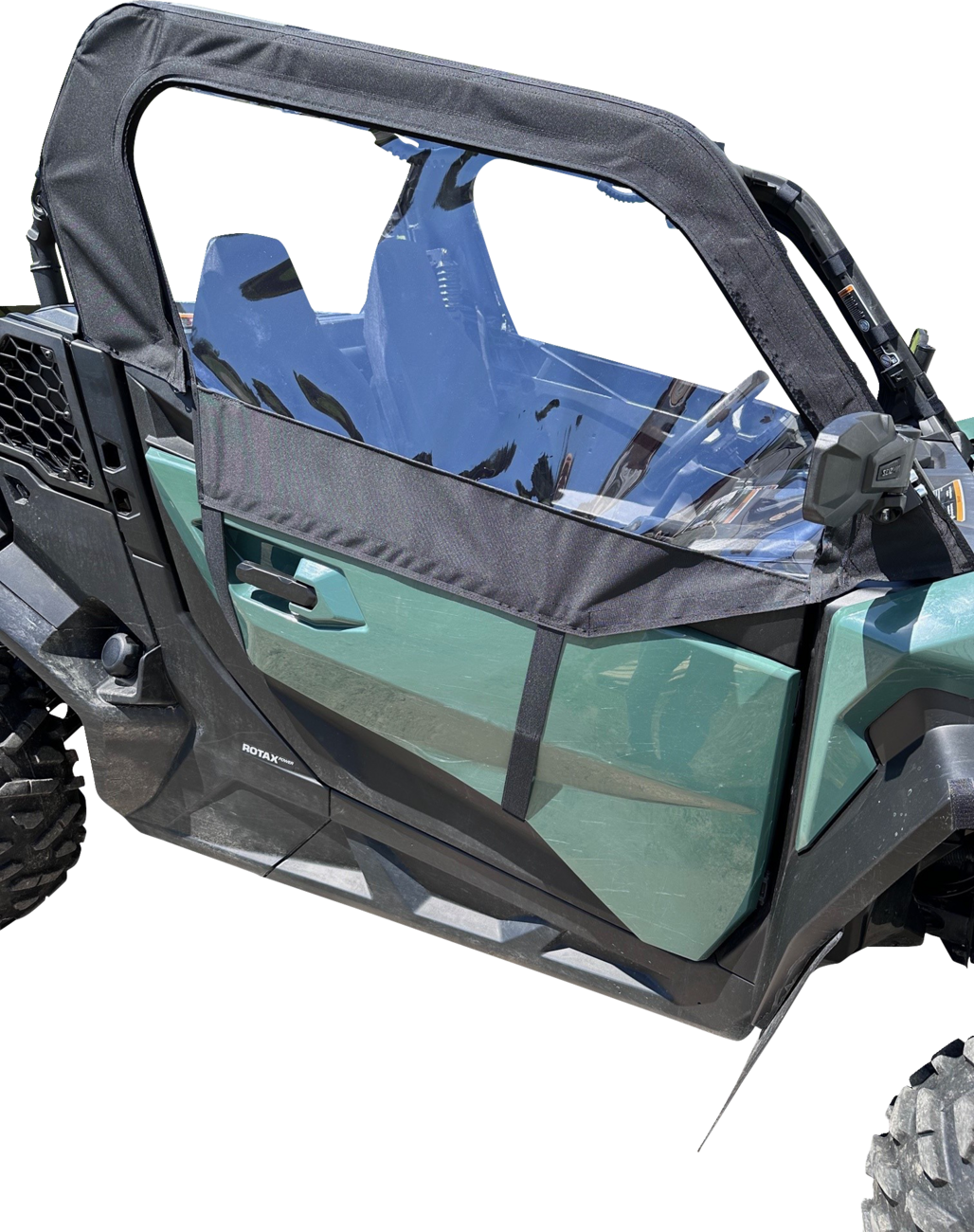 Side view of a green off-road utility vehicle with a black frame door featuring a clear plastic window. The rugged vehicle has large treaded tires, visible seats inside, and is set against a plain white background.
