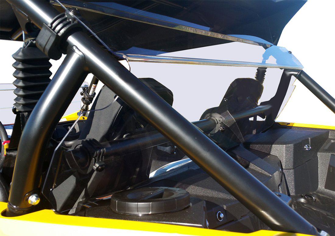 Close-up of the Yamaha Yxz Rear Shield-Gp 2016-2018 installed, highlighting black metal bars, shocks, and mechanical components. Part of the yellow frame and dashboard are visible with sky showing through the open roof.