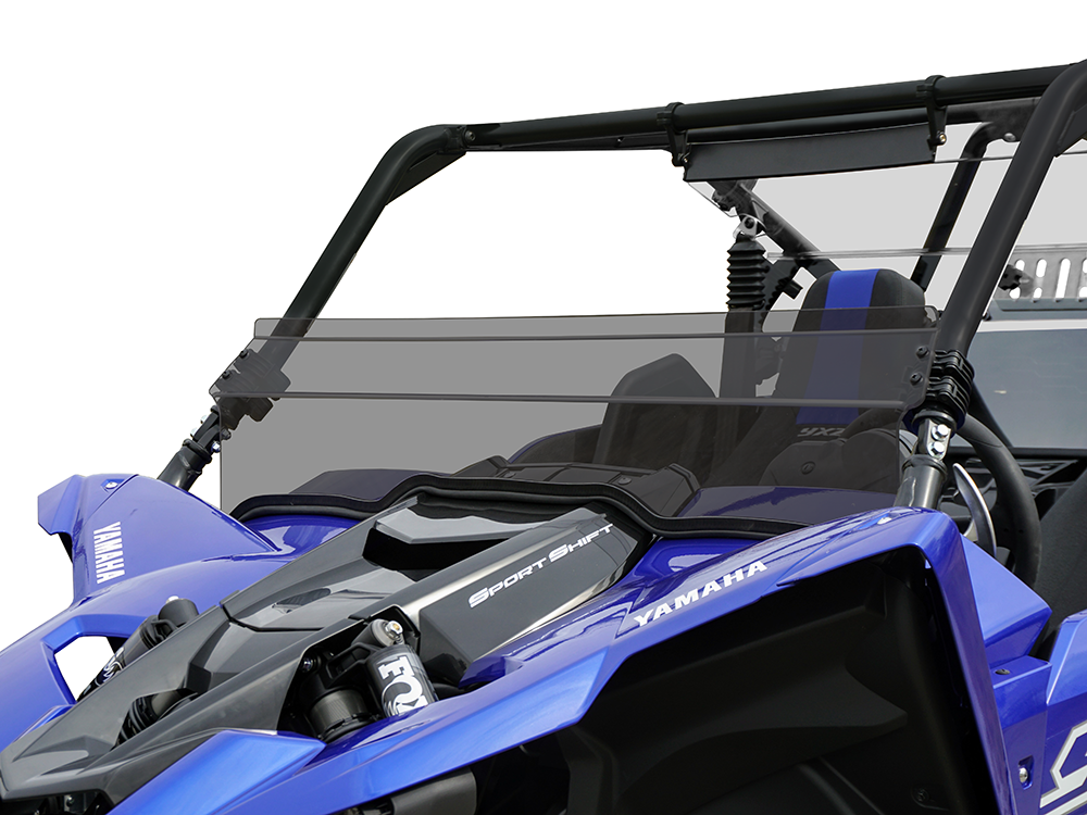 A close-up of a Yamaha Yxz 2019 featuring the Dark Tint Short Shield-Gp, with a blue hood, open cockpit, black roll cage, tinted windshield, branding labels, and partially visible seats and steering wheel.