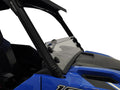 Close-up of a Polaris General Clear Short Shield Hard Coated Scratch Resistant (2016+) mounted on a blue off-road vehicle, showing the black support bars and clear acrylic window at the front and driver’s side against a white background.