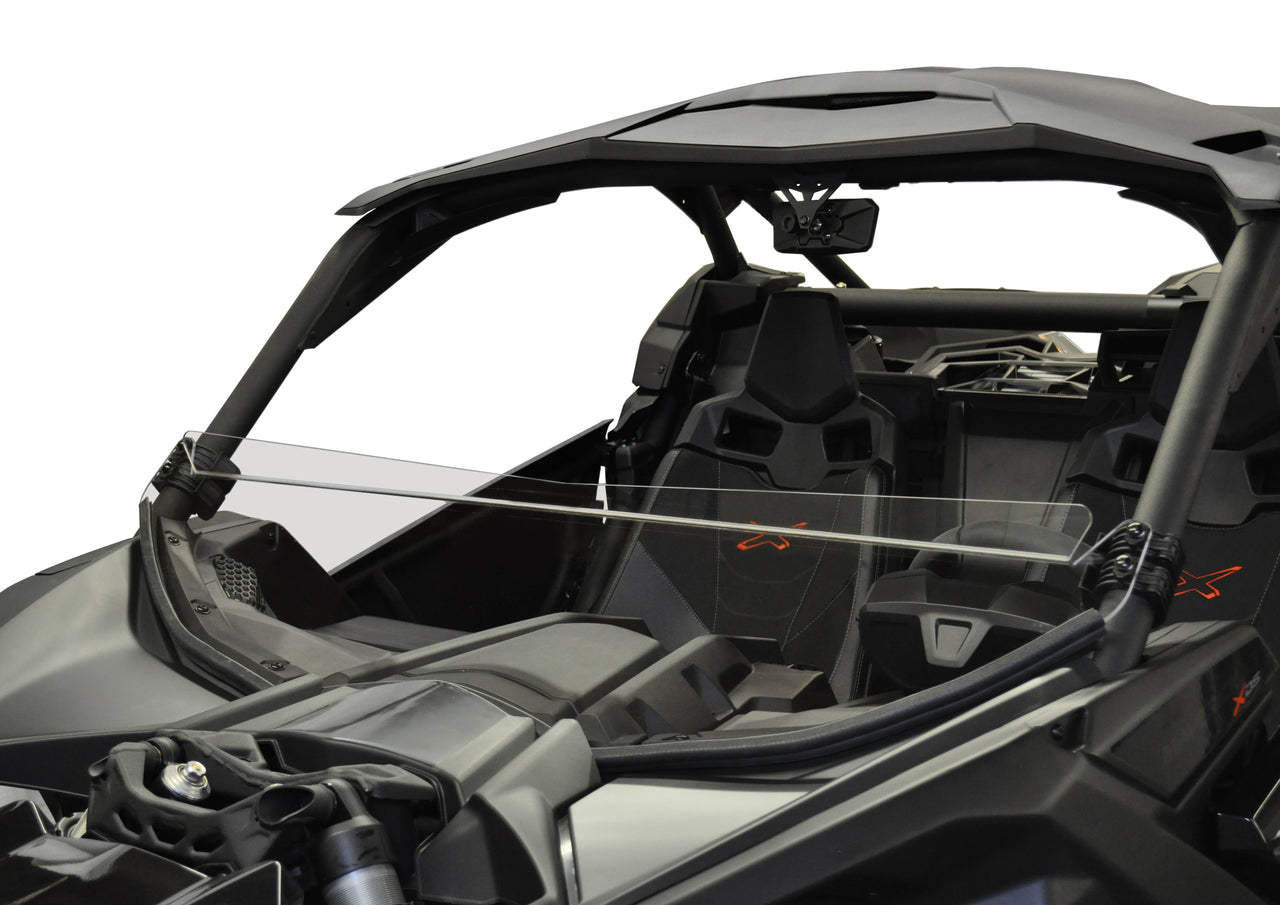 A Can Am Maverick X-3 (2017+) with a hard coated, scratch resistant short windshield. Matte black exterior, open angular cockpit, two racing seats, solid roof—rugged interior made for adventure, all set against a plain white background.