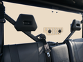The image displays the back seat of a Cf Moto U-Force 1000 featuring black leather seats, two headrests, and a metal mounting bracket for the tinted rear windshield (GP 2019+) attached to the roll cage. The background is plain and light-colored.